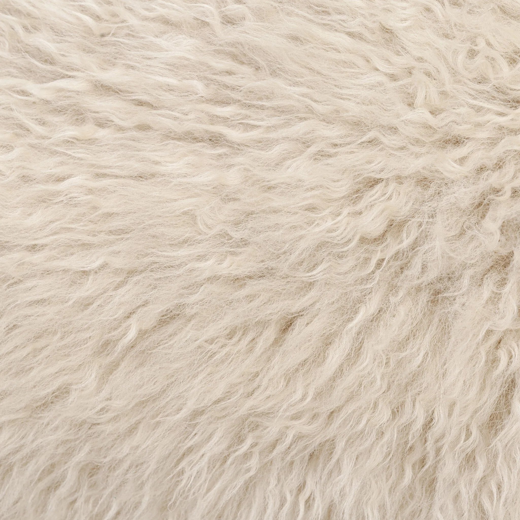 A textural take on a timeless silhouette. Hammered iron frames a squared seat and bolster back upholstered in off-white Mongolian fur Amethyst Home provides interior design, new home construction design consulting, vintage area rugs, and lighting in the Tampa metro area.