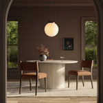 Mixed materials at their finest. Brown parawood forms a slight, simple frame for squared seating of neutral performance-grade upholstery. Charcoal top-grain leather backing takes this modern-minded dining chair to the next level Amethyst Home provides interior design, new home construction design consulting, vintage area rugs, and lighting in the Los Angeles metro area.