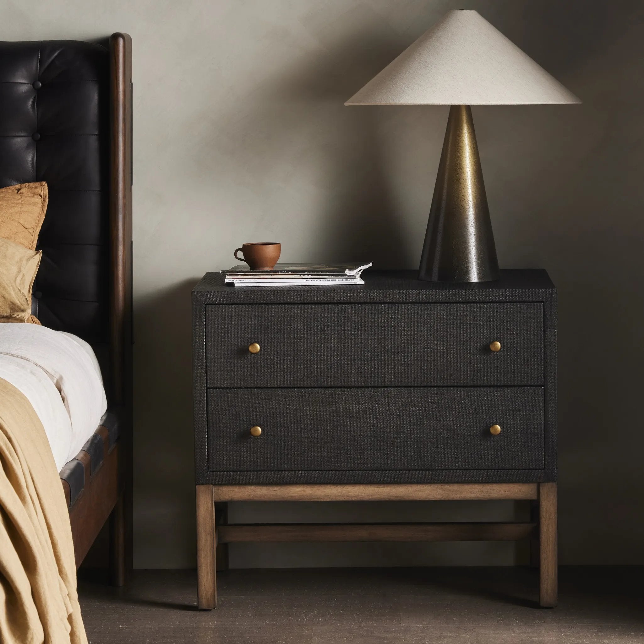 Featuring Fiona Black Raffia Nightstand by Four Hands at Amethyst Home. Woven black raffia offers a texture-driven take on bedside storage. Antique brass-finished iron hardware adorns dual drawers supported by a solid mahogany base.Overall Dimensions: 30.00"w x 17.00"d x 26.50"hWeight : 59.74 lbsMaterials: Sugar Palm, Solid Mahogany, Iron. Amethyst Home provides interior design, new home construction design consulting, vintage area rugs, and lighting in the Monterey metro area.