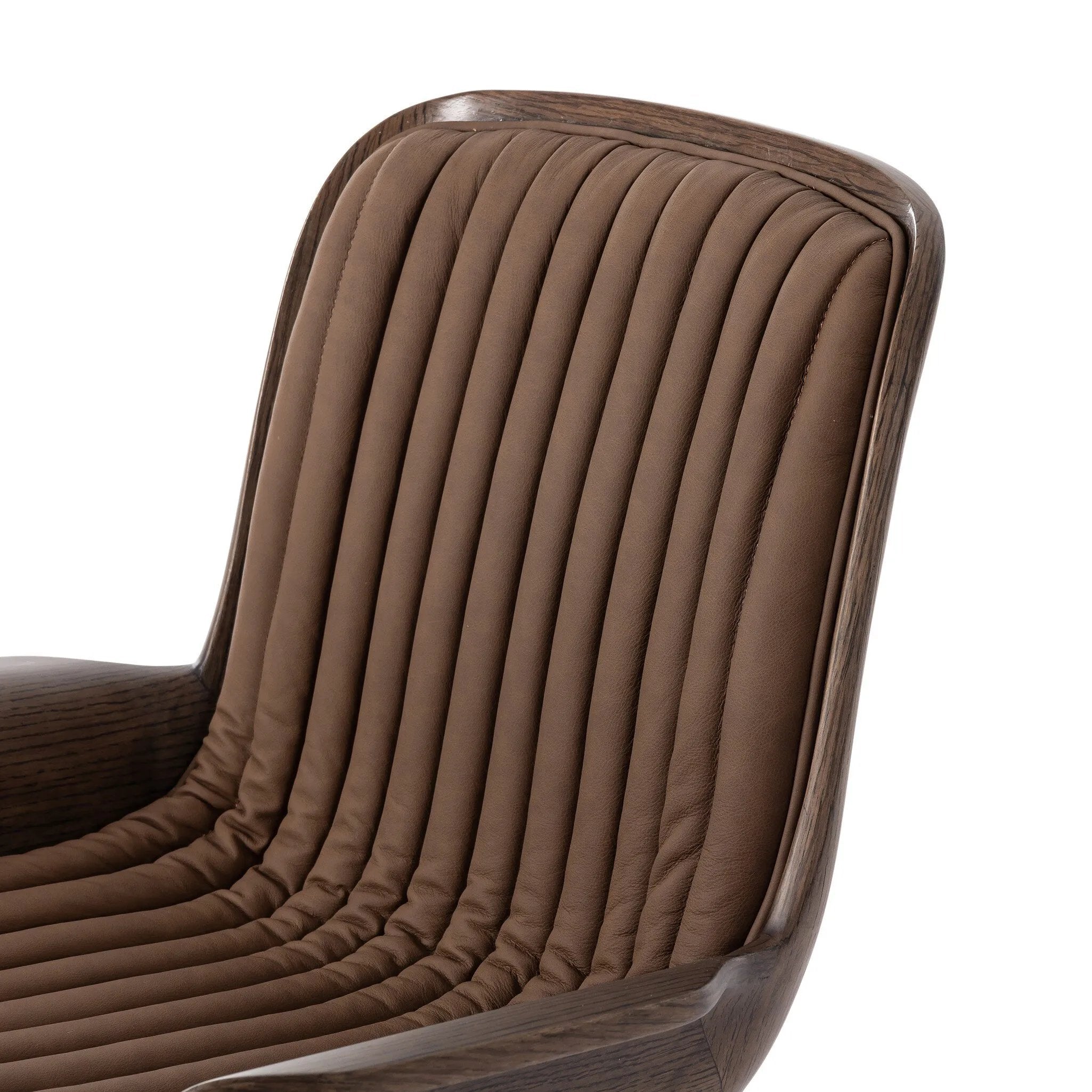 Elevate the office with one easy piece. Inspired by midcentury molded plywood chairs, brown oak veneer frames top-grain leather seat cushioning with slim, soft channeling. A 360-degree swivel burnished brass-finished base with casters allows for easy movement. Amethyst Home provides interior design, new home construction design consulting, vintage area rugs, and lighting in the Nashville metro area.