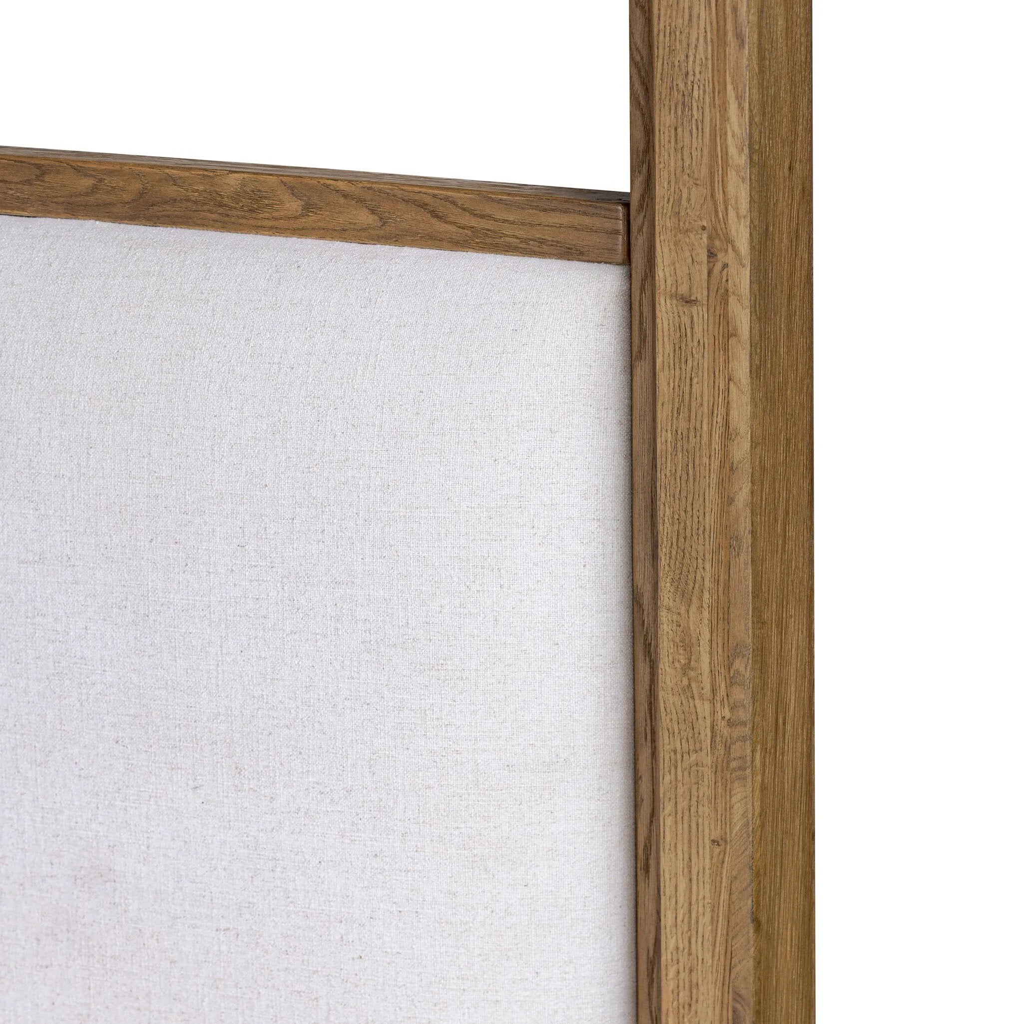 Minimalist and modern, this platform-style canopy bed is framed to a low profile and softened with an upholstered headboard. 