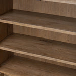 A rustic oak bar cabinet shapes subtly curved corners, bringing a handcrafted look to a minimalist form. Fixed center shelves, functional drawers and glass fronts for open display. Simple hardware is finished in an aged bronze Amethyst Home provides interior design, new home construction design consulting, vintage area rugs, and lighting in the Des Moines metro area.