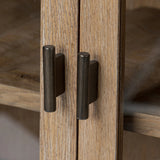 A rustic oak bar cabinet shapes subtly curved corners, bringing a handcrafted look to a minimalist form. Fixed center shelves, functional drawers and glass fronts for open display. Simple hardware is finished in an aged bronze Amethyst Home provides interior design, new home construction design consulting, vintage area rugs, and lighting in the Monterey metro area.