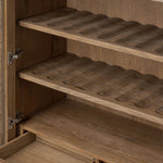 A rustic oak bar cabinet shapes subtly curved corners, bringing a handcrafted look to a minimalist form. Fixed center shelves, functional drawers and glass fronts for open display. Simple hardware is finished in an aged bronze Amethyst Home provides interior design, new home construction design consulting, vintage area rugs, and lighting in the Salt Lake City metro area.