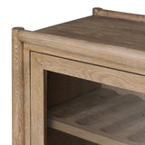 A rustic oak bar cabinet shapes subtly curved corners, bringing a handcrafted look to a minimalist form. Fixed center shelves, functional drawers and glass fronts for open display. Simple hardware is finished in an aged bronze Amethyst Home provides interior design, new home construction design consulting, vintage area rugs, and lighting in the San Diego metro area.