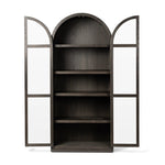Featuring Hepburn Dark Anthracite Oak Veneer Cabinet by Four Hands at Amethyst Home. Beautifully arched with a flush plinth base, a versatile oak cabinet features a dark, rich finish. With generous interior shelving, a tempered glass front allows you to showcase favorite books and treasures — letting anyone who enters your space know exactly who you are. . Amethyst Home provides interior design, new home construction design consulting, vintage area rugs, and lighting in the Los Angeles metro area.
