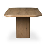 This modern take on the traditional trestle table features two angular bases, mirrored and united by softened square center beam. Dramatically angled legs pull the eye toward beautifully curved detailing. Crafted of oak with a light, natural finish. Amethyst Home provides interior design, new home construction design consulting, vintage area rugs, and lighting in the Washington metro area.