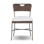 A light, airy take on the traditional bistro shape. This outdoor dining chair features exaggerated splayed legs and a curved X-shaped stretcher, with a handle detail cut out of the woven seat back. Finished with a seat cushion. Cover or store indoors during inclement weather and when not in use. Amethyst Home provides interior design, new home construction design consulting, vintage area rugs, and lighting in the Kansas City metro area.