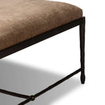 This French Industrialist-inspired cocktail ottoman features a curved stretcher base of bronzed hammered iron and a velvety seat in a versatile earth tone. Style with a sofa or sectional to create an extra surface in your living space, or for bonus seating. Amethyst Home provides interior design, new home construction design consulting, vintage area rugs, and lighting in the Nashville metro area.