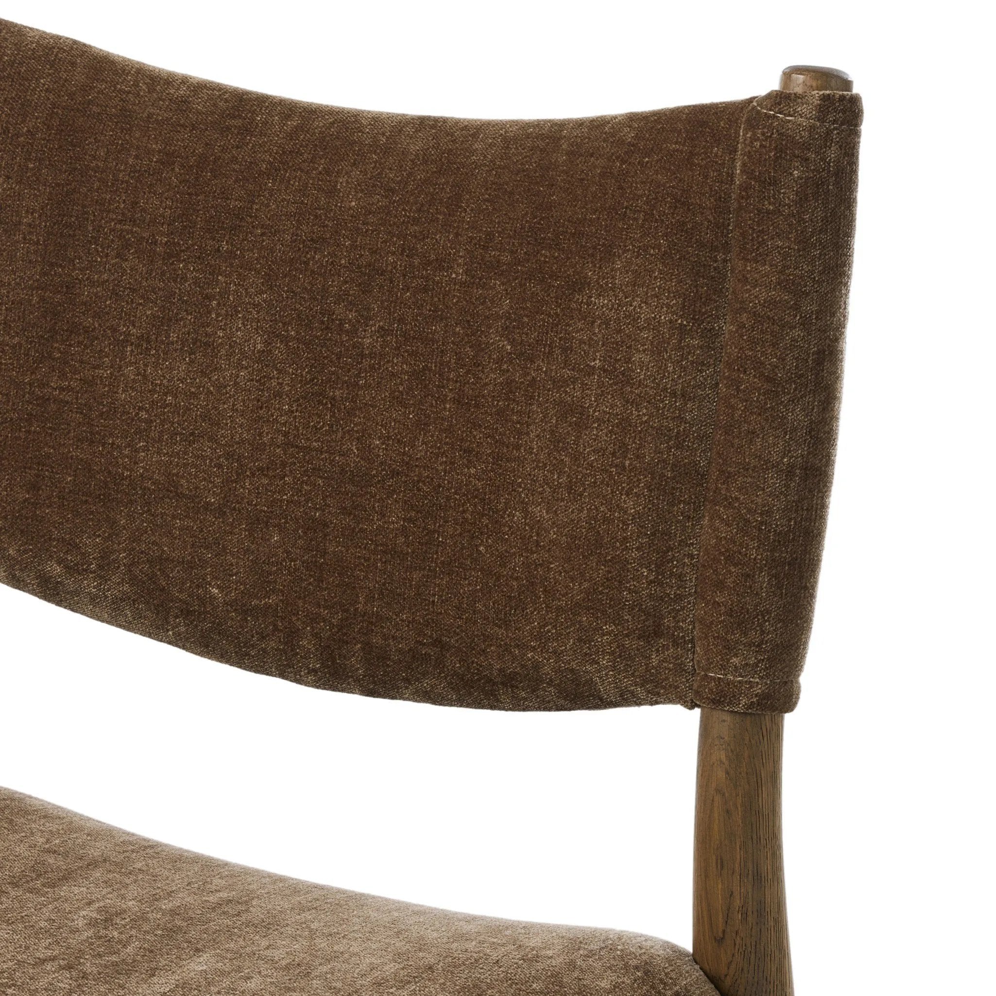A midcentury-inspired piece brought to modern times. A supportive, sling-style back and seat cushion are upholstered in a soft, velvety fabric, with toasted oak armless framing Amethyst Home provides interior design, new home construction design consulting, vintage area rugs, and lighting in the Des Moines metro area.