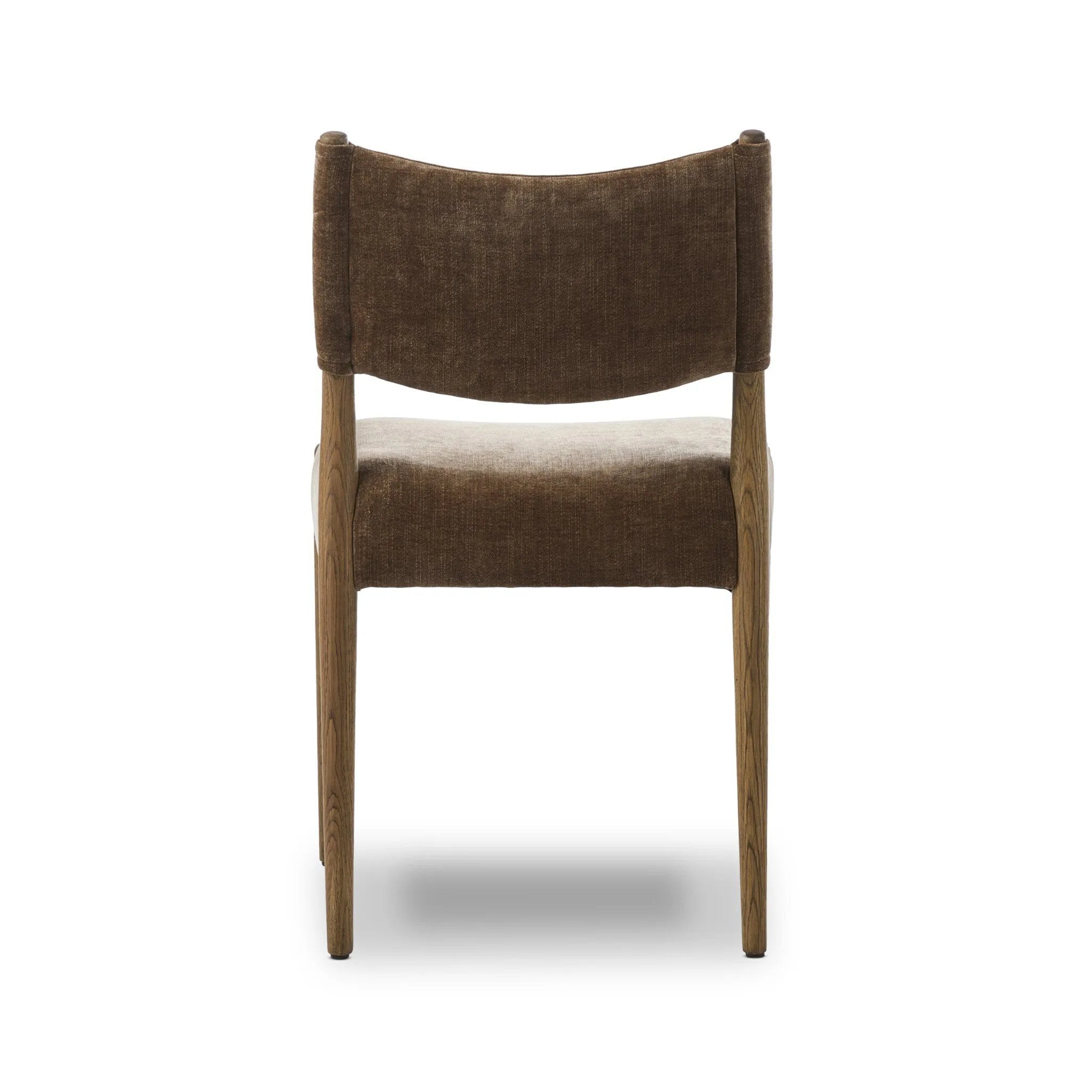 A midcentury-inspired piece brought to modern times. A supportive, sling-style back and seat cushion are upholstered in a soft, velvety fabric, with toasted oak armless framing Amethyst Home provides interior design, new home construction design consulting, vintage area rugs, and lighting in the Park City metro area.
