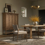 A midcentury-inspired piece brought to modern speed. A supportive, sling-style back and seat cushion are upholstered in a soft, velvety fabric, with toasted oak arms prime for the head of the table Amethyst Home provides interior design, new home construction design consulting, vintage area rugs, and lighting in the Omaha metro area.