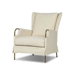 Bridging timeless tradition with modern edge, this upholstered chair strikes a one-of-a-kind silhouette. Its fixed, skirted slipcover and subtle winged back offer a classic feel, while a unique metal arm reveal  and slightly flared legs create an unparalleled look. Amethyst Home provides interior design, new home construction design consulting, vintage area rugs, and lighting in the Boston metro area.