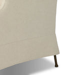 Bridging timeless tradition with modern edge, this upholstered chair strikes a one-of-a-kind silhouette. Its fixed, skirted slipcover and subtle winged back offer a classic feel, while a unique metal arm reveal  and slightly flared legs create an unparalleled look. Amethyst Home provides interior design, new home construction design consulting, vintage area rugs, and lighting in the Nashville metro area.