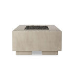 This outdoor fire table is a welcoming centerpiece designed for gathering. Made from glass-reinforced concrete, each piece is naturally finished with deep tones of pewter and dark grey. The monolithic shape is completed with lavastones in the center, bringing together a bold, monochromatic look. Amethyst Home provides interior design, new home construction design consulting, vintage area rugs, and lighting in the Scottsdale metro area.