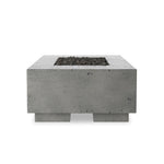 This outdoor fire table is a welcoming centerpiece designed for gathering. Made from glass-reinforced concrete, each piece is naturally finished with deep tones of pewter and dark grey. The monolithic shape is completed with lavastones in the center, bringing together a bold, monochromatic look. Amethyst Home provides interior design, new home construction design consulting, vintage area rugs, and lighting in the Calabasas metro area.