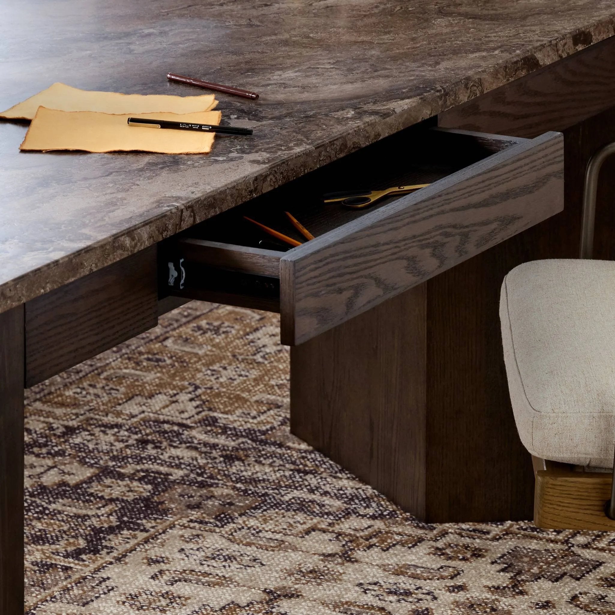 Featuring Lawson Brown Oak Veneer Desk by Four Hands at Amethyst Home. The traditional writing desk, elevated with mixed materials. Vein-rich marble tops an angular brown oak base, with two pencil drawers for storage. Overall Dimensions: 73.50"w x 28.00"d x 30.00"h. Amethyst Home provides interior design, new home construction design consulting, vintage area rugs, and lighting in the Monterey metro area.