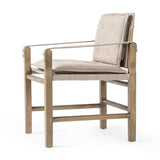 Inspired by a vintage safari-style frame, this dining chair is defined by the fluid strap arms. Semi-attached cushions in taupe performance fabric, finished with button tufting details. Framed out by warm parawood. Amethyst Home provides interior design, new home construction design consulting, vintage area rugs, and lighting in the Alpharetta metro area.