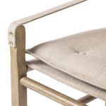 Inspired by a vintage safari-style frame, this dining chair is defined by the fluid strap arms. Semi-attached cushions in taupe performance fabric, finished with button tufting details. Framed out by warm parawood. Amethyst Home provides interior design, new home construction design consulting, vintage area rugs, and lighting in the Los Angeles metro area.