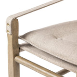 Inspired by a vintage safari-style frame, this dining chair is defined by the fluid strap arms. Semi-attached cushions in taupe performance fabric, finished with button tufting details. Framed out by warm parawood. Amethyst Home provides interior design, new home construction design consulting, vintage area rugs, and lighting in the Los Angeles metro area.