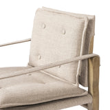 Inspired by a vintage safari-style frame, this dining chair is defined by the fluid strap arms. Semi-attached cushions in taupe performance fabric, finished with button tufting details. Framed out by warm parawood. Amethyst Home provides interior design, new home construction design consulting, vintage area rugs, and lighting in the Miami metro area.