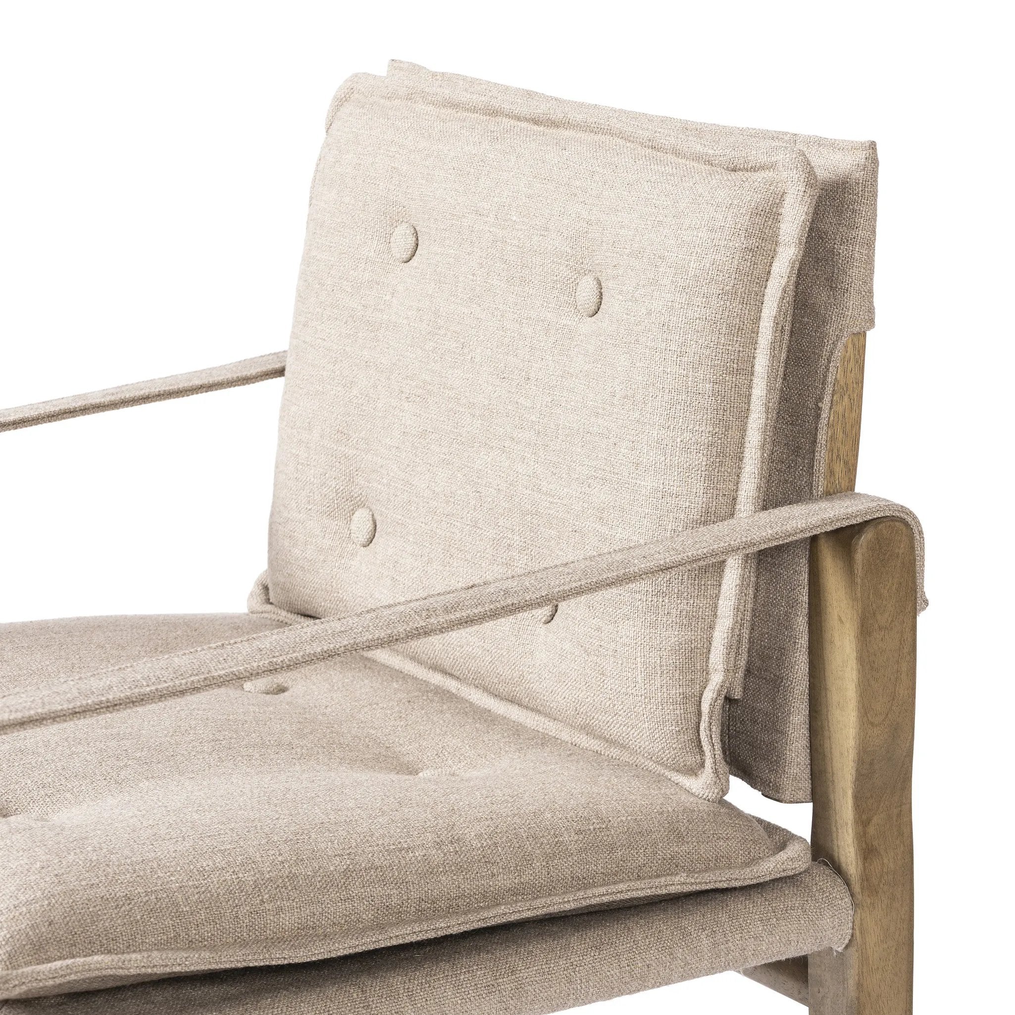 Inspired by a vintage safari-style frame, this dining chair is defined by the fluid strap arms. Semi-attached cushions in taupe performance fabric, finished with button tufting details. Framed out by warm parawood. Amethyst Home provides interior design, new home construction design consulting, vintage area rugs, and lighting in the Miami metro area.