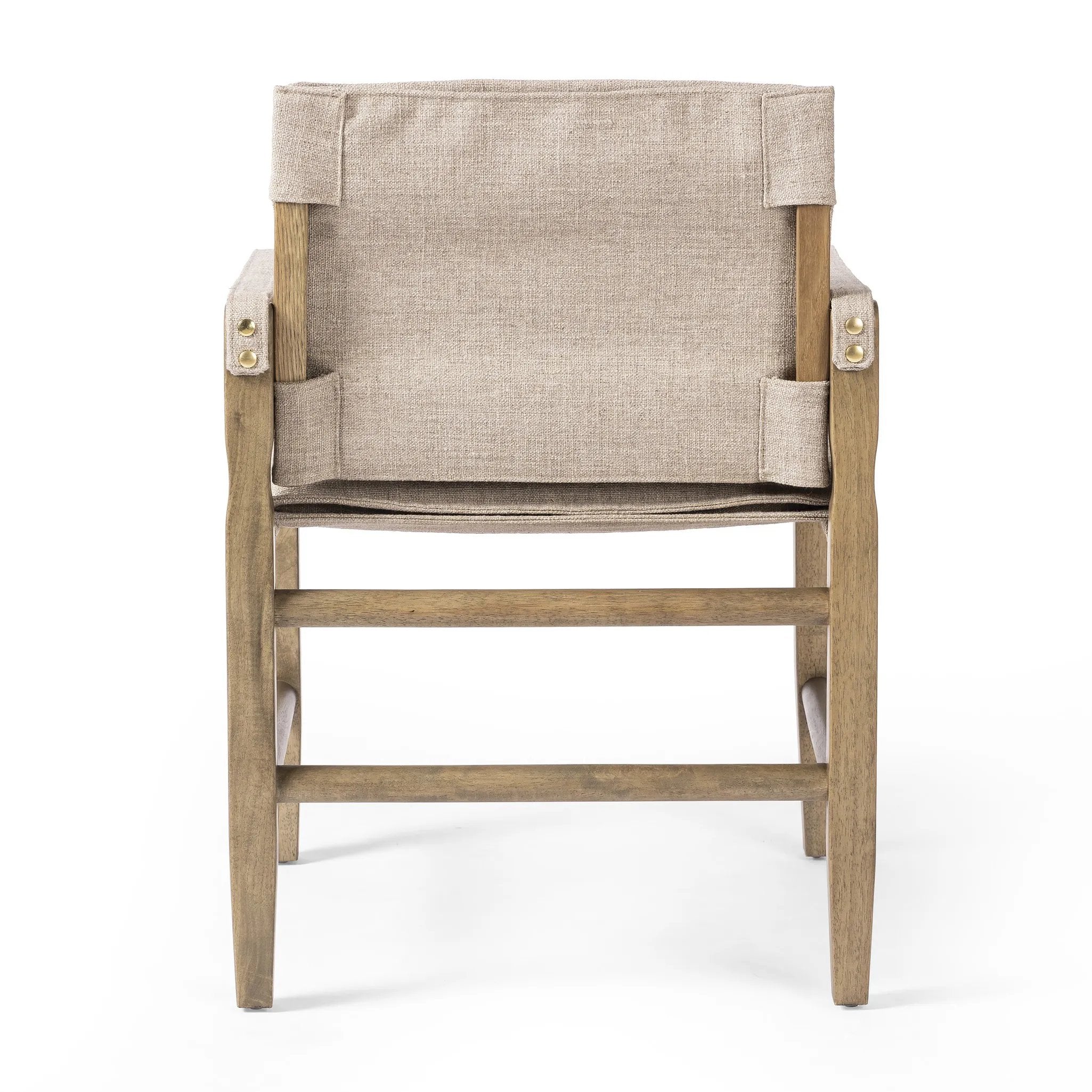 Inspired by a vintage safari-style frame, this dining chair is defined by the fluid strap arms. Semi-attached cushions in taupe performance fabric, finished with button tufting details. Framed out by warm parawood. Amethyst Home provides interior design, new home construction design consulting, vintage area rugs, and lighting in the Seattle metro area.