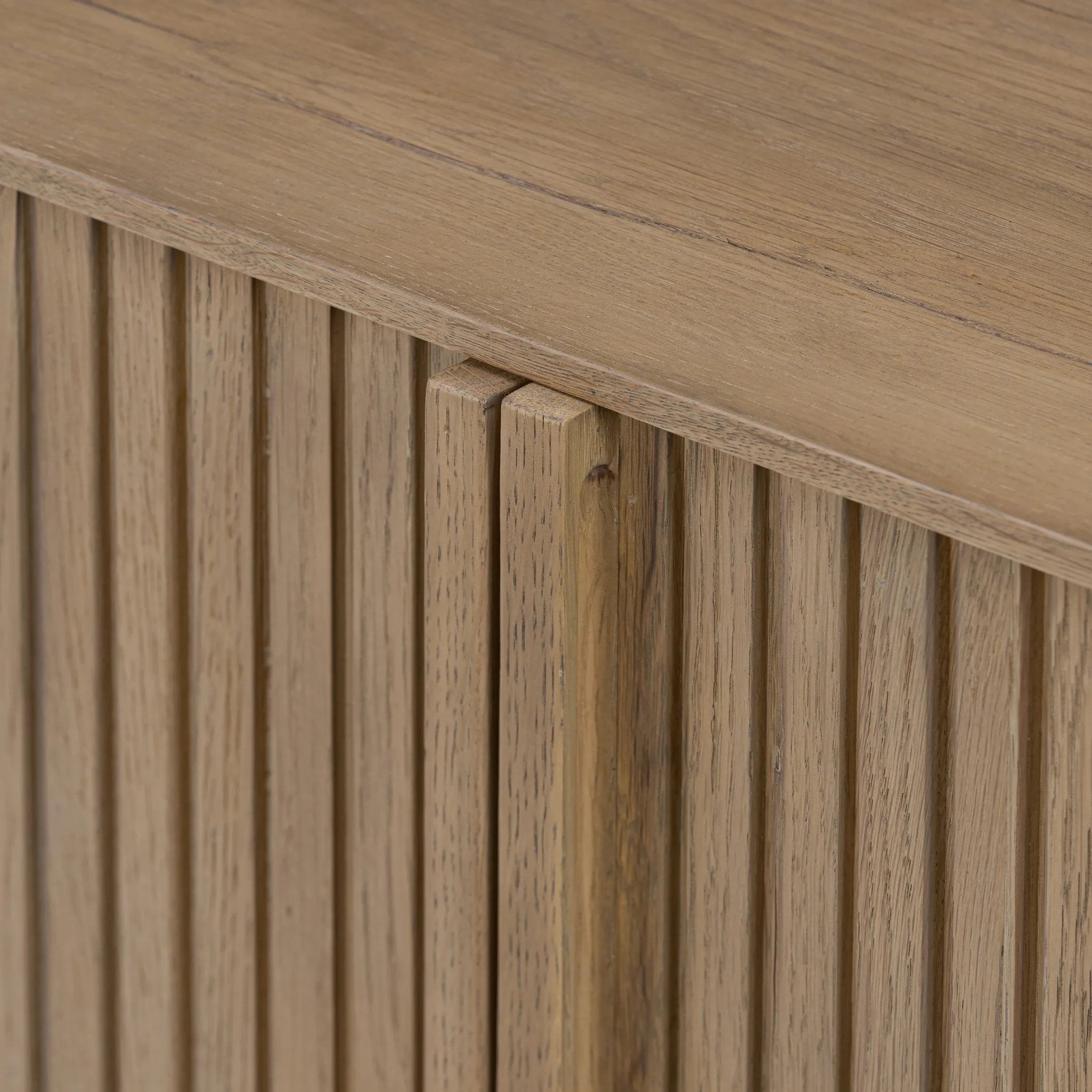 Made from rustic-finished oak with a plinth-style base, clean angles and linear reeding define this midcentury-spirited sideboard. Fully finished interior for a beautiful look inside and out. Designed in partnership with longtime Four Hands collaborator Thomas Bina and Brazilian designer Ronald Sasson Amethyst Home provides interior design, new home construction design consulting, vintage area rugs, and lighting in the Tampa metro area.