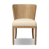 The barrel back dining chair, refreshed. Light oak shapes an armless frame and curved rear legs that almost appear to flow into the seat back. A comfy seat is upholstered in high-performance fabric, while reeding details on the back create a sense of perception play. Amethyst Home provides interior design, new home construction design consulting, vintage area rugs, and lighting in the Alpharetta metro area.