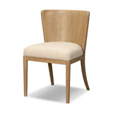 The barrel back dining chair, refreshed. Light oak shapes an armless frame and curved rear legs that almost appear to flow into the seat back. A comfy seat is upholstered in high-performance fabric, while reeding details on the back create a sense of perception play. Amethyst Home provides interior design, new home construction design consulting, vintage area rugs, and lighting in the Laguna Beach metro area.