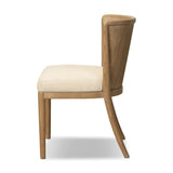 The barrel back dining chair, refreshed. Light oak shapes an armless frame and curved rear legs that almost appear to flow into the seat back. A comfy seat is upholstered in high-performance fabric, while reeding details on the back create a sense of perception play. Amethyst Home provides interior design, new home construction design consulting, vintage area rugs, and lighting in the Washington metro area.