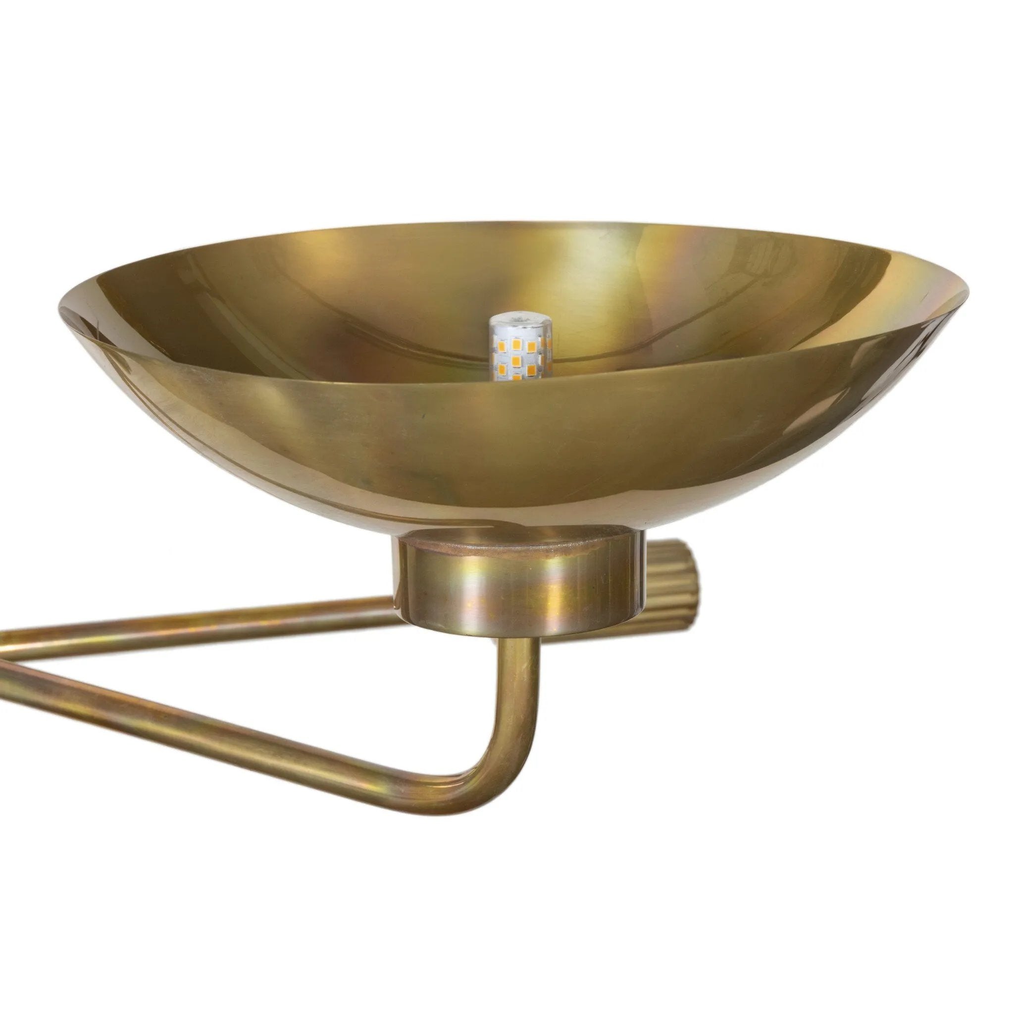 Artfully diffused lighting inspired by 1920s glam. Three glowing discs nestle within curved brass reflectors, creating a warm, expansive ambiance. Reeding detail on the socket and stem add texture, while a hand-burnt brass finish ensures each piece ages uniquely, developing character over time Amethyst Home provides interior design, new home construction design consulting, vintage area rugs, and lighting in the Austin metro area.