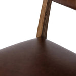 Both modern and traditional, toasted oak frames this high-back, armless dining chair. Finished with a rich brown top-grain leather, with hanging straps affixed to the back Amethyst Home provides interior design, new home construction design consulting, vintage area rugs, and lighting in the Boston metro area.