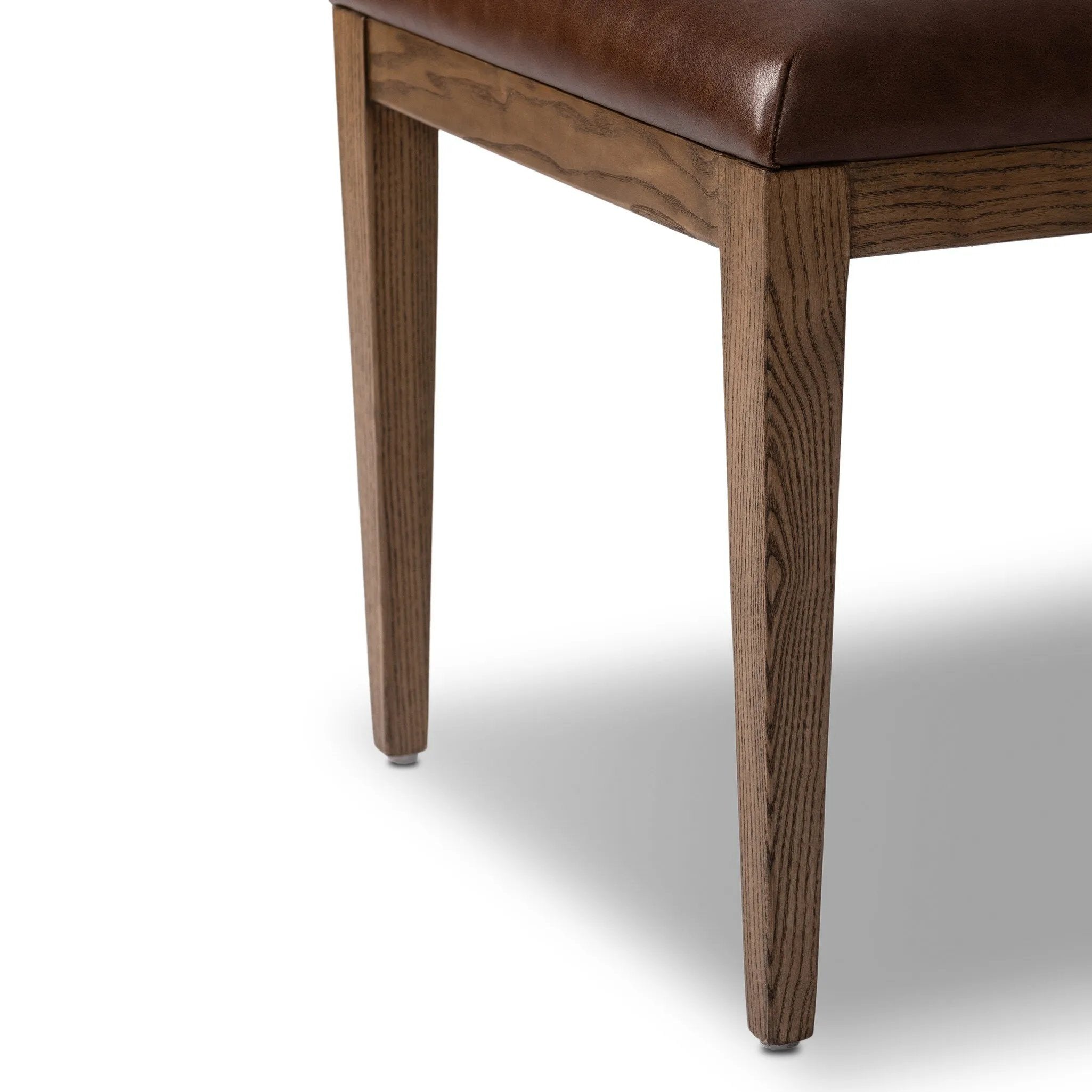 Both modern and traditional, toasted oak frames this high-back, armless dining chair. Finished with a rich brown top-grain leather, with hanging straps affixed to the back Amethyst Home provides interior design, new home construction design consulting, vintage area rugs, and lighting in the Park City metro area.