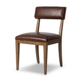 Both modern and traditional, toasted oak frames this high-back, armless dining chair. Finished with a rich brown top-grain leather, with hanging straps affixed to the back Amethyst Home provides interior design, new home construction design consulting, vintage area rugs, and lighting in the Tampa metro area.