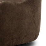 Modern wingback with a twist of barrel back design, this enveloping swivel chair comes with velvety upholstery in a deep brow