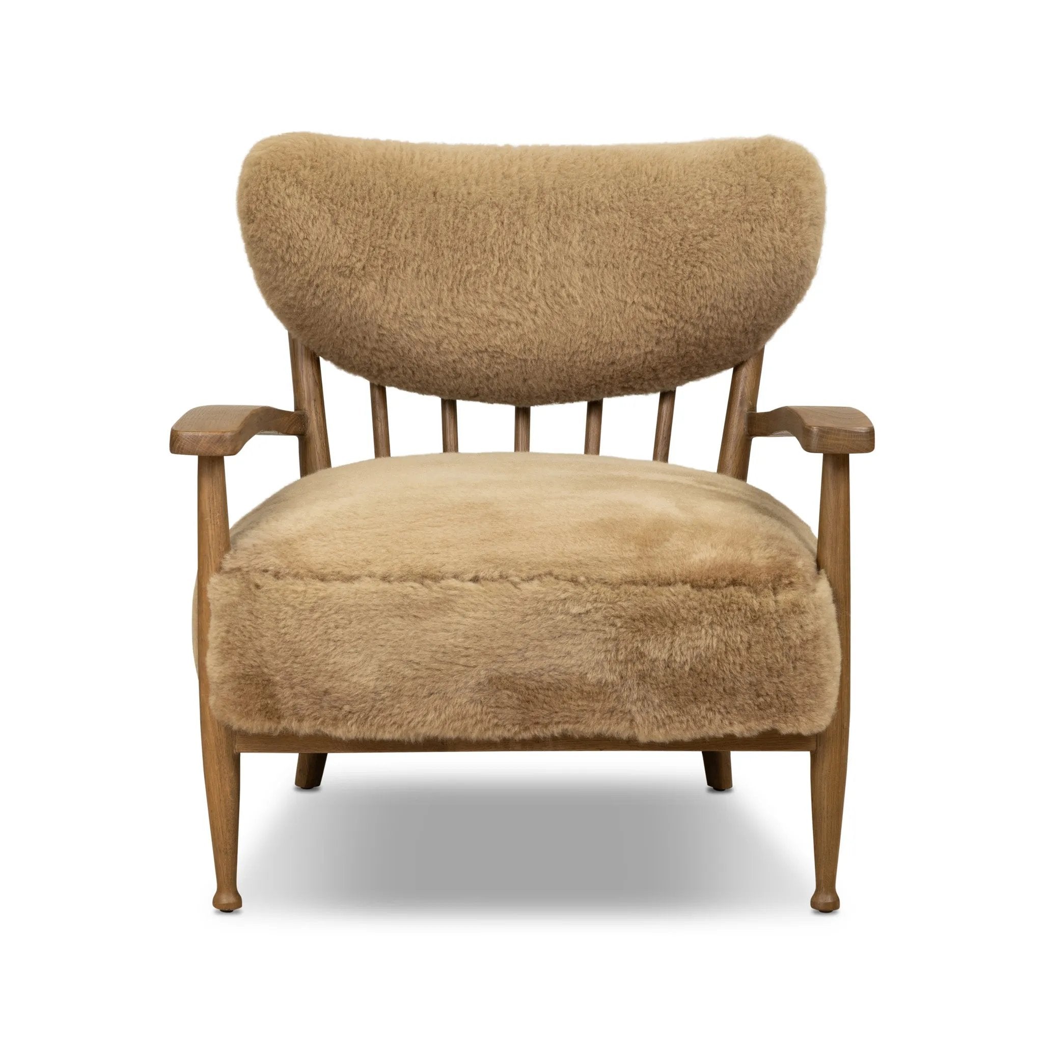 Classic Scandinavian design gets a supersoft update with a winged back panel of amber-finished oak floating above a chunky seat with exposed spindles. Paddle arms and ball feet add to the minimalist design. Covered in natural beige shearling for extra texture and comfort Amethyst Home provides interior design, new home construction design consulting, vintage area rugs, and lighting in the Seattle metro area.