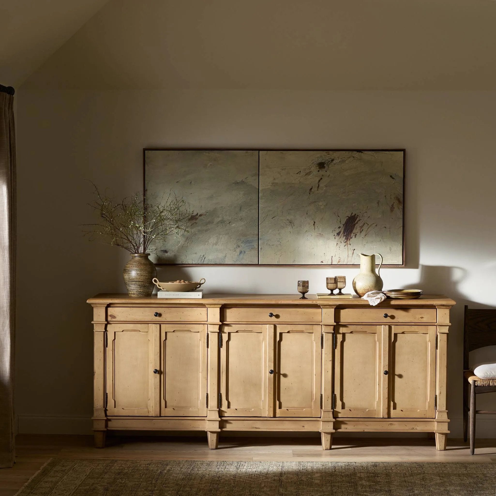 Inspired by European antiques, this solid pine sideboard features classic molding and detailing with distressed copper hardware for an authentic heirloom look and feel. Grand in scale with plenty of interior storage including three top drawers. Rear cutouts for cord management Amethyst Home provides interior design, new home construction design consulting, vintage area rugs, and lighting in the Alpharetta metro area.
