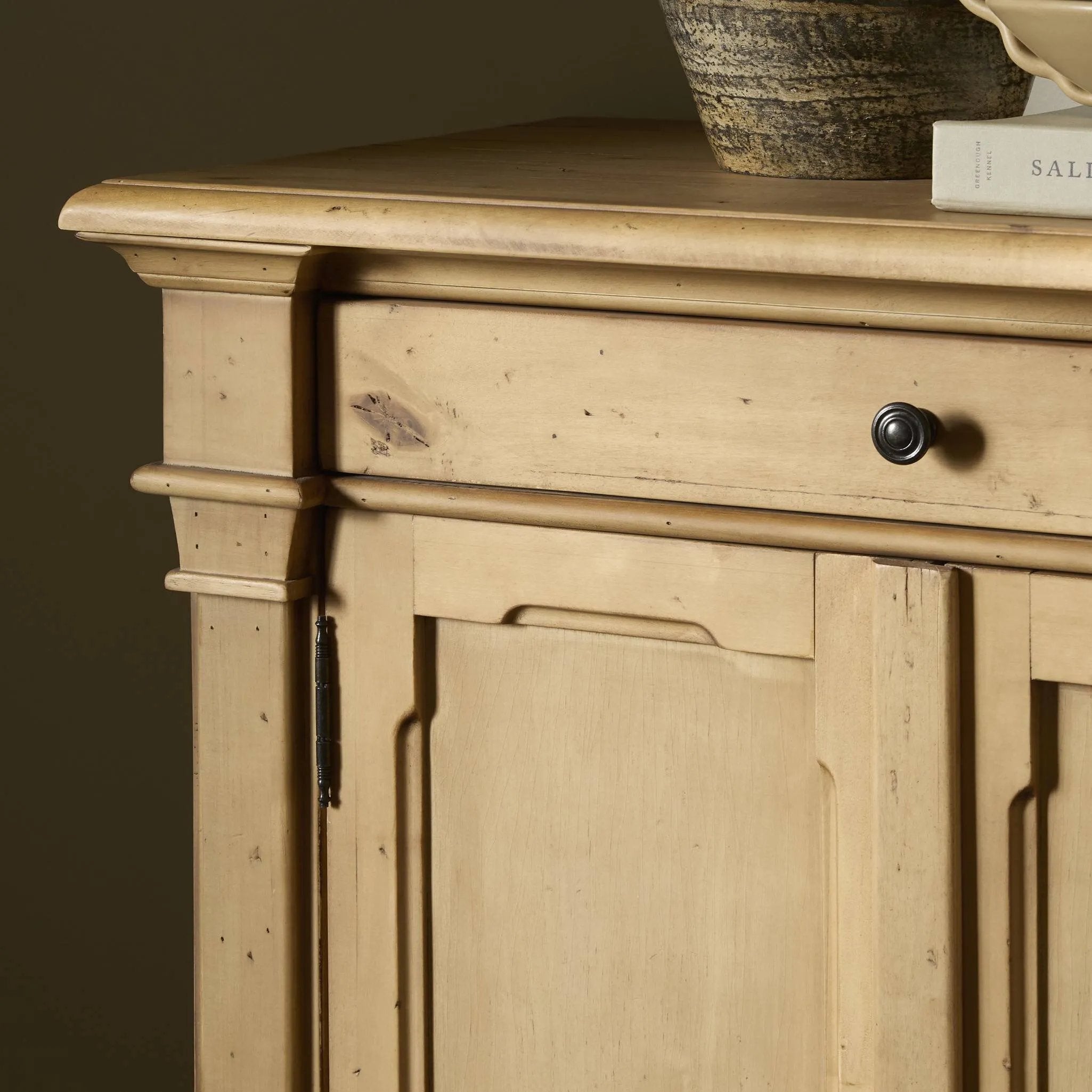 Inspired by European antiques, this solid pine sideboard features classic molding and detailing with distressed copper hardware for an authentic heirloom look and feel. Grand in scale with plenty of interior storage including three top drawers. Rear cutouts for cord management Amethyst Home provides interior design, new home construction design consulting, vintage area rugs, and lighting in the Laguna Beach metro area.