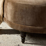 A traditional shape with modern styling, turned wooden legs complement the soft curves of this lounge-worthy chair. A chenill