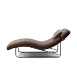 Contoured for comfort, this minimalist chaise is fixed with ideal ergonomics so you can simply sit back and unwind. Inspired by 1960s European design, the chaise blends a utilitarian aesthetic with high-quality tufting, stainless-steel framing, and smooth upholstery. The adjustable headrest is secured by a metal closure and magnetic strip. Amethyst Home provides interior design, new home construction design consulting, vintage area rugs, and lighting in the San Diego metro area.