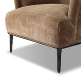 With elements of past eras at play, this updated Deco chair features a rounded back, sloped arms and a dramatic channel. The 