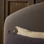 An arched headboard and simple frame act as the perfect canvas for your favorite bedding. A soft textural linen slipcover in a rich brown hue contributes a cozy yet refined look Amethyst Home provides interior design, new home construction design consulting, vintage area rugs, and lighting in the San Diego metro area.