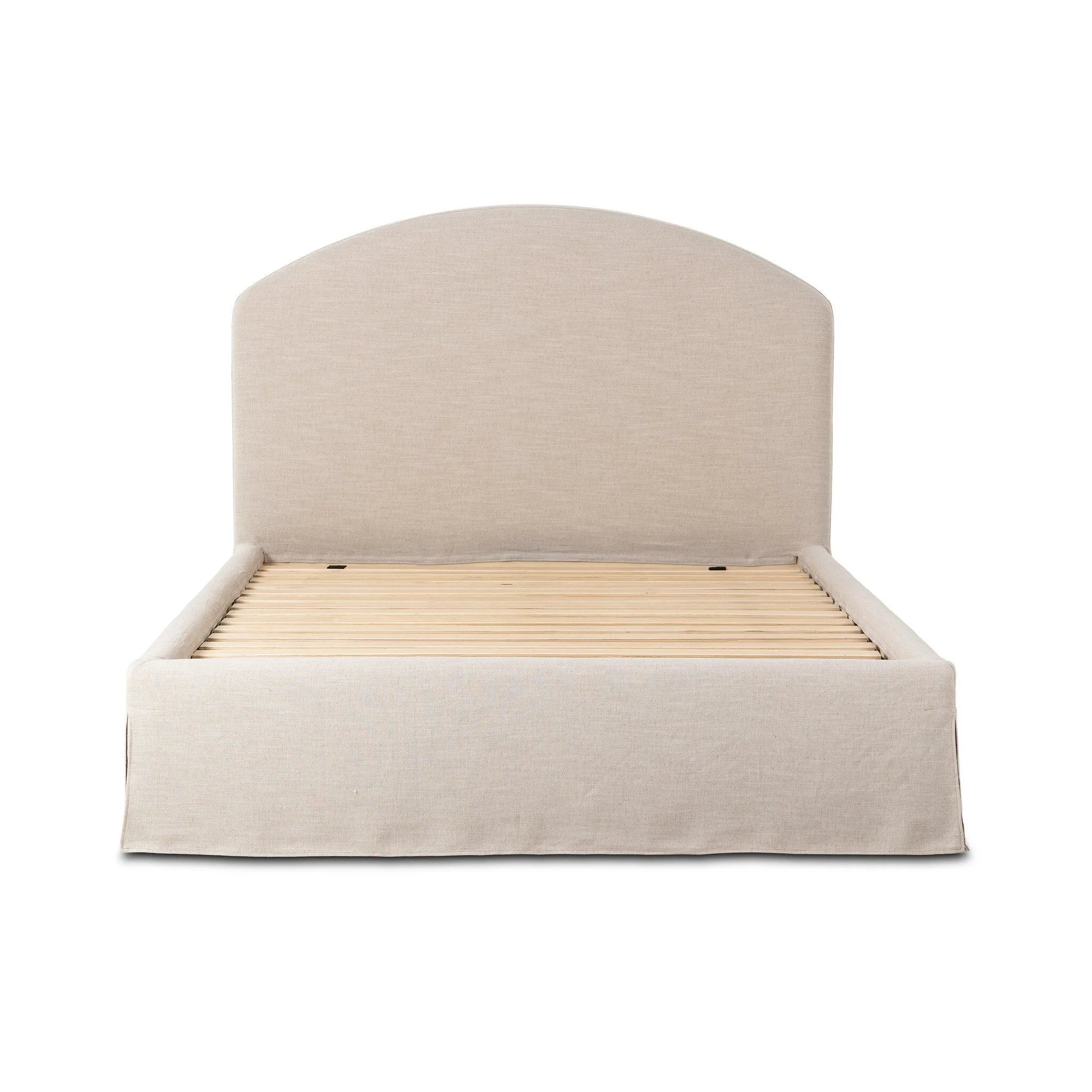 An arched headboard and simple frame act as the perfect canvas for your favorite bedding. A soft textural linen slipcover in a neutral hue contributes a cozy yet refined look Amethyst Home provides interior design, new home construction design consulting, vintage area rugs, and lighting in the Tampa metro area.