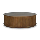 An artisanal take on texture. Made from amber-finished mindi with a plinth-style base, a reeding pattern is carved around the entirety of this coffee table table for a fresh, approachable look.As lovers of natural aesthetics at Amethyst, we love the warm modern inspired Ona Coffee Table - Amber Mindi Veneer. Amethyst Home provides interior design, new home construction design consulting, vintage area rugs, and lighting in the Houston metro area.