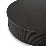 An artisanal take on texture. Made from black-finished mindi with a plinth-style base, a reeding pattern is carved around the entirety of this coffee table table for a fresh, approachable look.As fans of clean style at Amethyst, we love the nature inspired Ona Coffee Table - Smoked Black Mindi - Smoked Black Mindi Veneer. Amethyst Home provides interior design, new home construction design consulting, vintage area rugs, and lighting in the Alpharetta metro area.