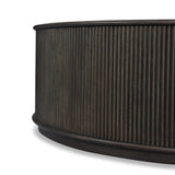An artisanal take on texture. Made from black-finished mindi with a plinth-style base, a reeding pattern is carved around the entirety of this coffee table table for a fresh, approachable look.As fans of clean style at Amethyst, we love the nature inspired Ona Coffee Table - Smoked Black Mindi - Smoked Black Mindi Veneer. Amethyst Home provides interior design, new home construction design consulting, vintage area rugs, and lighting in the Omaha metro area.