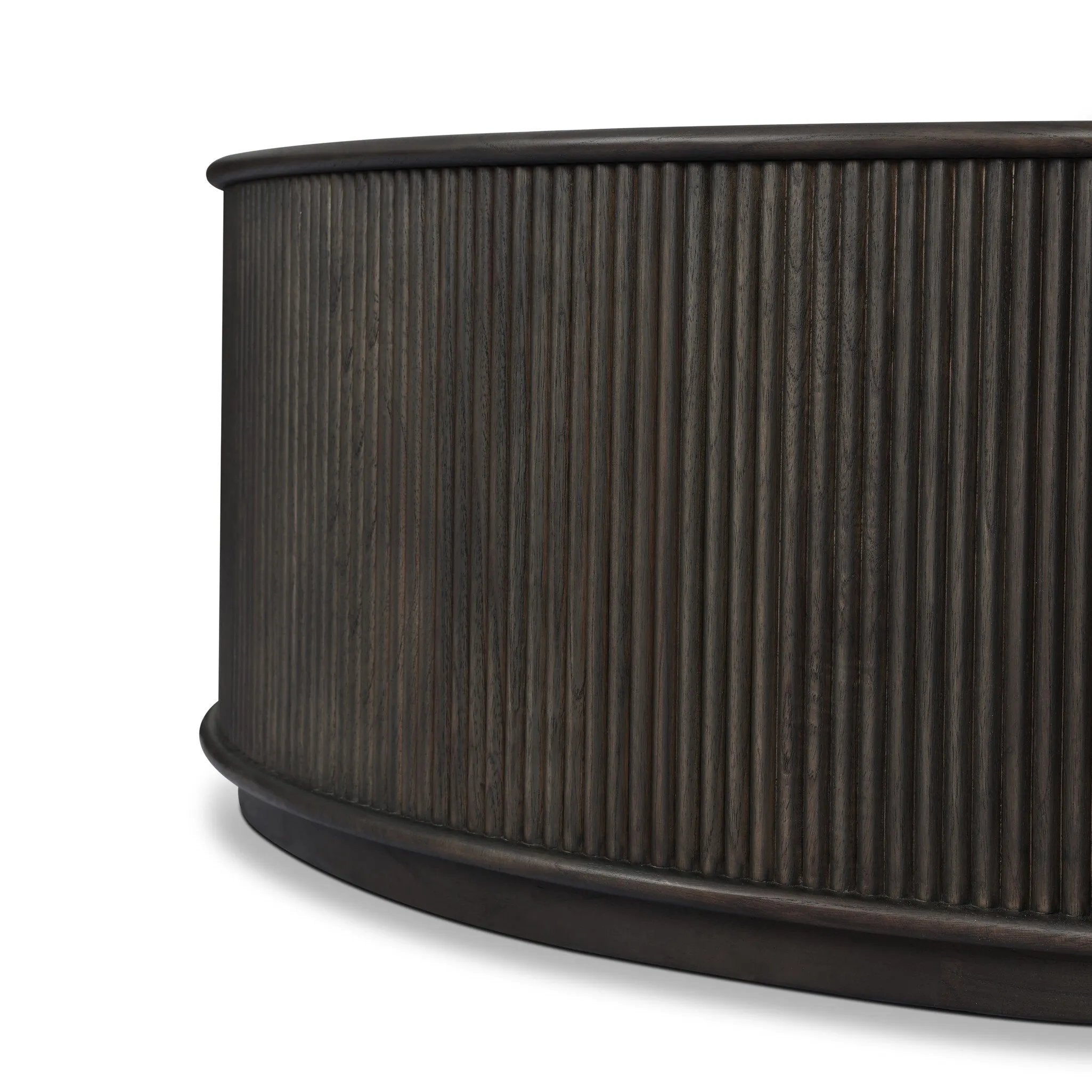 An artisanal take on texture. Made from black-finished mindi with a plinth-style base, a reeding pattern is carved around the entirety of this coffee table table for a fresh, approachable look.As fans of clean style at Amethyst, we love the nature inspired Ona Coffee Table - Smoked Black Mindi - Smoked Black Mindi Veneer. Amethyst Home provides interior design, new home construction design consulting, vintage area rugs, and lighting in the Omaha metro area.