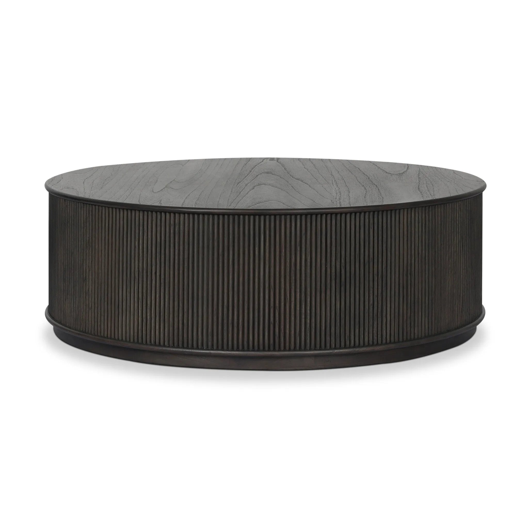 An artisanal take on texture. Made from black-finished mindi with a plinth-style base, a reeding pattern is carved around the entirety of this coffee table table for a fresh, approachable look.As fans of clean style at Amethyst, we love the nature inspired Ona Coffee Table - Smoked Black Mindi - Smoked Black Mindi Veneer. Amethyst Home provides interior design, new home construction design consulting, vintage area rugs, and lighting in the Seattle metro area.