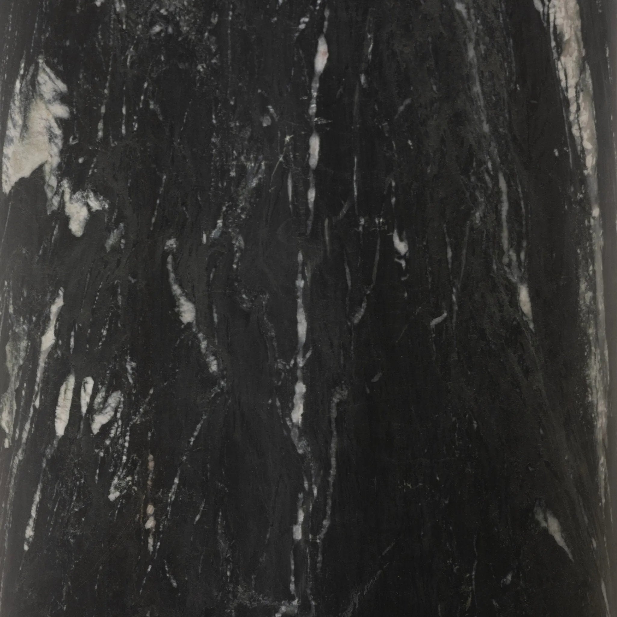 A material-driven piece inspired by post-modernism. A subtly organic round tabletop pairs with a swooped, sculptural pedestal base. Made from black marble for a striking, timeless look, with contrasting white veining playing up this piece's curves.As enthusiasts of luxe aesthetics at Amethyst, we love the designer inspired Oric Bistro Table. Amethyst Home provides interior design, new home construction design consulting, vintage area rugs, and lighting in the Austin metro area.